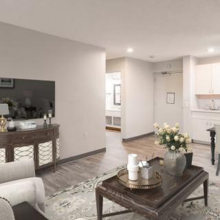 A modern living room with a comfortable sofa, stylish coffee table, and a TV setup.
