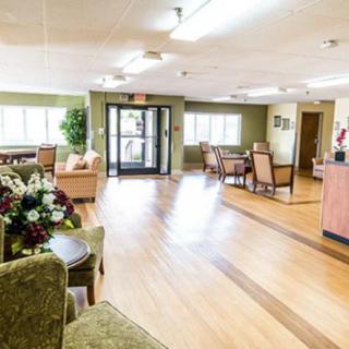A bright and inviting lobby area with comfortable seating and wooden floors.
