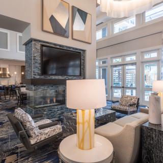 A modern living room with stylish furniture and large windows.