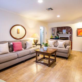 A cozy living room with comfortable sofas, a wooden coffee table, and stylish decor.