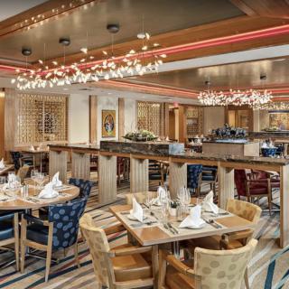 A spacious and elegantly decorated restaurant interior with neatly arranged tables and modern lighting.