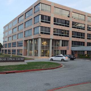 A modern office building featuring large glass windows and a stylish facade.