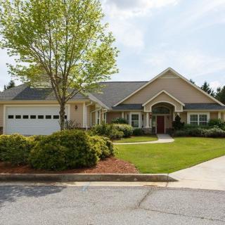 A suburban house with a well-maintained lawn and attached garage.