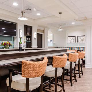 A modern bar interior with stylish seating and elegant lighting.