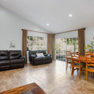 Spacious living and dining area with modern furniture and large windows.