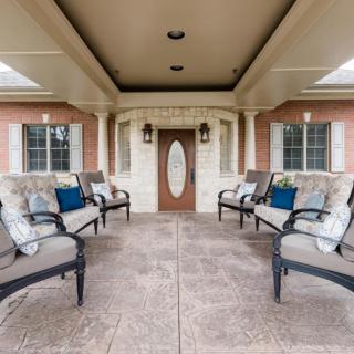 A spacious patio with comfortable seating and elegant architecture.