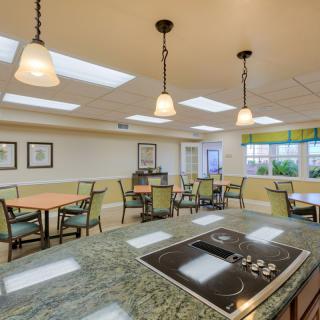 A modern indoor kitchen and dining area with stylish lighting and seating.