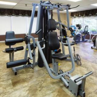 A multi-station gym machine in a fitness center.