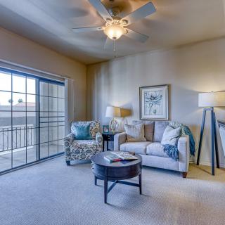 A cozy living room with comfortable seating and ample natural light.