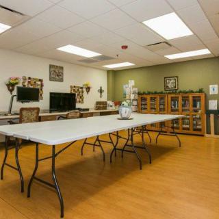 An indoor meeting room with a large conference table, several chairs, and decorative elements.