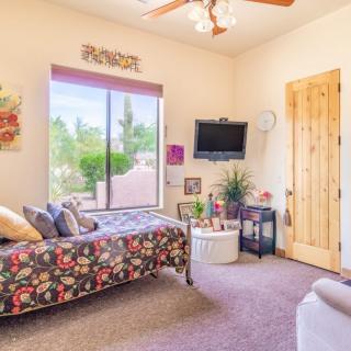 A cozy bedroom with a floral daybed and modern decor.