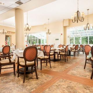 Elegant restaurant dining area with large windows and ornate chandeliers.