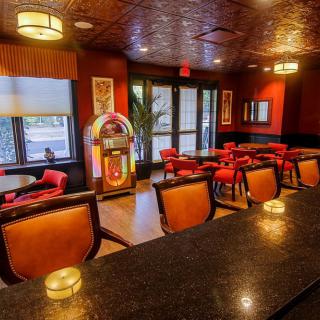 A cozy retro diner interior featuring vintage decor and a classic jukebox.