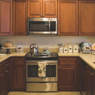 A cozy kitchen with wooden cabinets and stainless steel appliances.