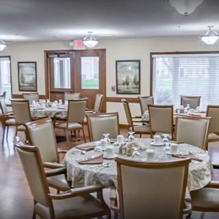 A well-arranged dining room with neatly set tables and comfortable chairs.