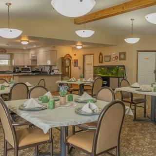 A cozy dining area with neatly set tables and comfortable lighting.