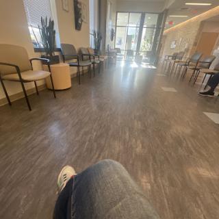 A spacious waiting room with modern decor, featuring comfortable seating and abundant natural light.