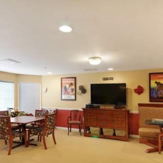 A cozy living room with a dining area, television, and stylish decor.