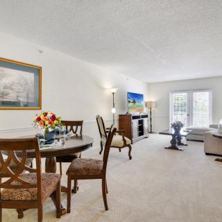 A spacious living and dining area with elegant furnishings and decor.