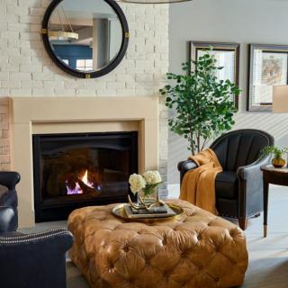 A cozy living room with a fireplace, comfortable seating, and stylish decor.