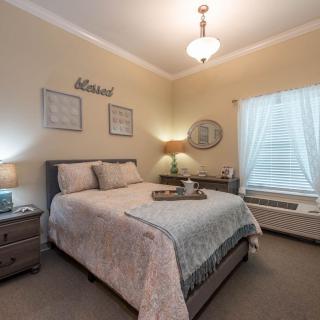 A cozy bedroom with elegant furnishings and warm lighting.