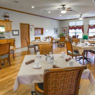 A cozy dining room setup with neatly arranged tables and chairs.