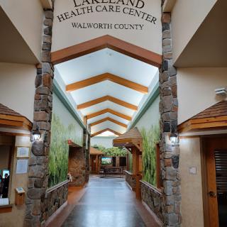 A welcoming corridor inside the Lakeland Health Care Center, showcasing a blend of modern design and natural elements.
