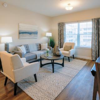 A beautifully designed modern living room featuring comfortable seating and ample natural light.