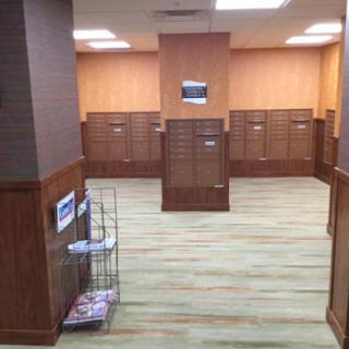 A view of a mailroom featuring wooden mailboxes and a clean, organized layout.