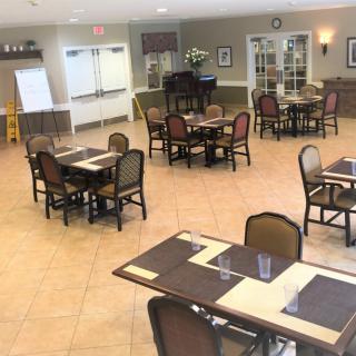 An empty dining area with neatly arranged tables and chairs.