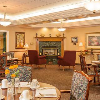 A cozy dining room with a fireplace and elegant table settings.