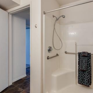 Modern bathroom with a walk-in shower and towel hanging on the rail.