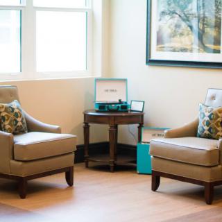 A cozy seating area with two armchairs and a side table, perfect for relaxing.