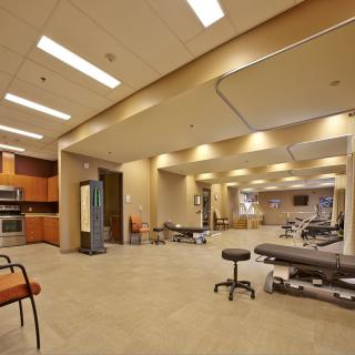 A modern physical therapy clinic with therapy beds and a spacious layout.
