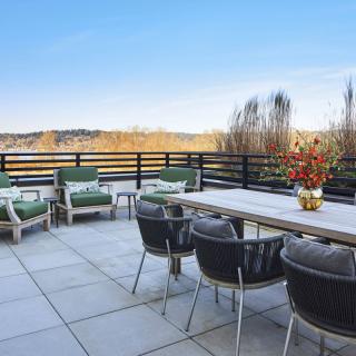 A spacious outdoor patio with comfortable seating and a scenic view.