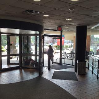 A view of the entrance area featuring a revolving door and spacious lobby.