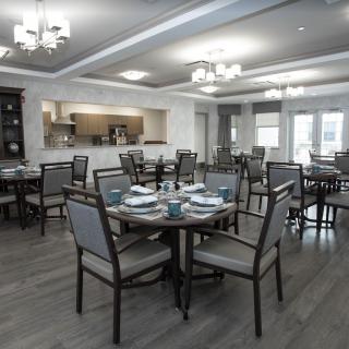 A modern dining area with neatly arranged tables and chairs.