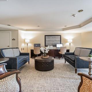 A cozy living room with sofas, chairs, and a computer desk.