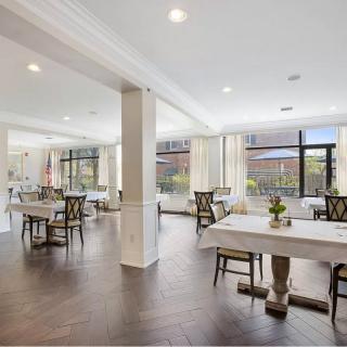 A spacious, well-lit dining area with modern decor and elegant furnishings.
