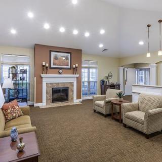 A spacious living room with a fireplace, comfortable seating, and elegant interior design.