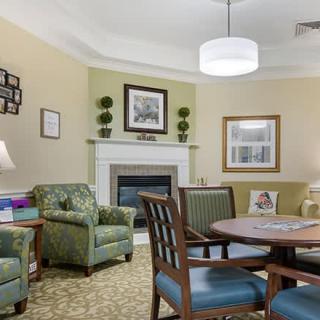 A cozy living room with comfortable seating, a fireplace, and elegant decor.