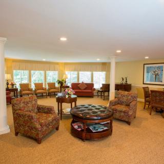 Spacious living room with elegant furniture and large windows.