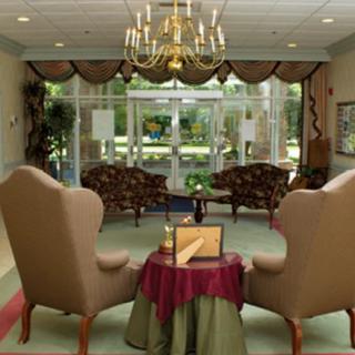 A cozy sitting area with elegant furnishings and a chandelier.