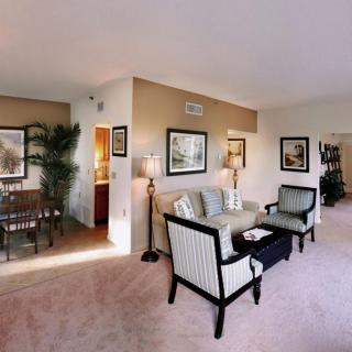 A spacious living room with elegant furniture and a connected dining area.