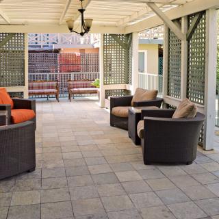 An inviting outdoor patio with comfortable seating under a covered structure.