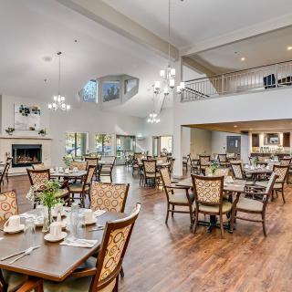 A spacious dining area with elegant decor and neatly arranged tables and chairs.