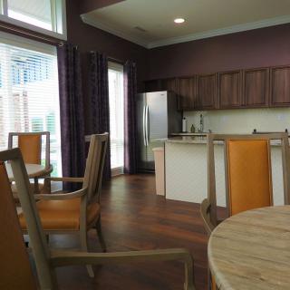 A modern kitchen and dining area with wooden furniture and stainless steel appliances.