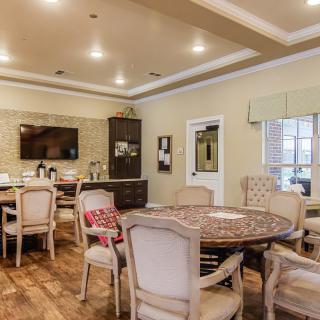 A cozy dining room with elegant furniture and warm lighting.