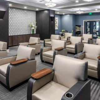 A modern waiting room with arranged seating and elegant decor.