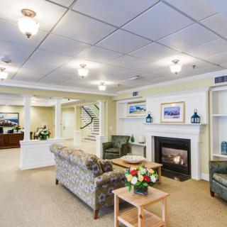 A cozy living room with a fireplace, comfortable sofas, and elegant decor.